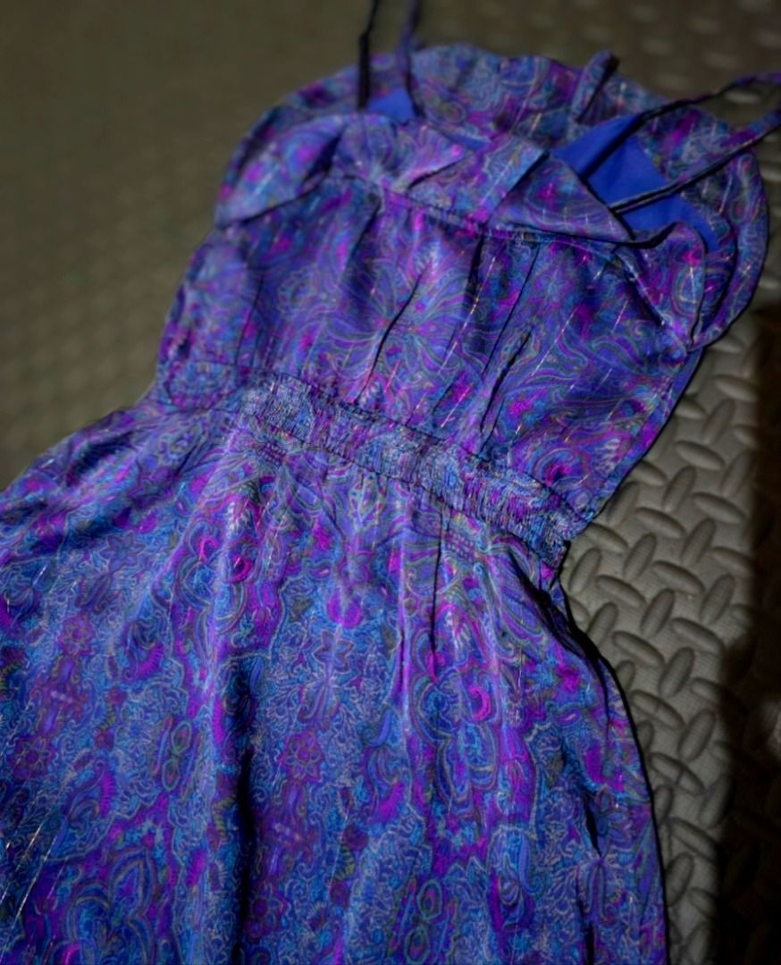 Purple Paisley Pattern Long Dress Size Small (Category: Dresses) located in Lapu Lapu. Submitted by goodstuff_cebu (Listing ID 1466949104, Image 2). Description: - Size: Small to medium - Design: Purple and blue paisley print with subtle shimmer thread - Details: Spaghetti straps, smocked elastic waist, and ruffled hem - Material: Flowy, lightweight fabric - Versatility: Perfect for warm weather or layering - Condition: Good as new (Ready to ship