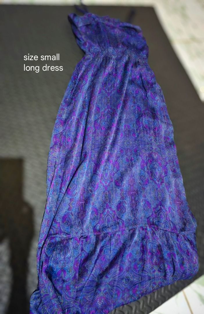 Purple Paisley Pattern Long Dress Size Small (Category: Dresses) located in Lapu Lapu. Submitted by goodstuff_cebu (Listing ID 1466949104, Image 1). Description: - Size: Small to medium - Design: Purple and blue paisley print with subtle shimmer thread - Details: Spaghetti straps, smocked elastic waist, and ruffled hem - Material: Flowy, lightweight fabric - Versatility: Perfect for warm weather or layering - Condition: Good as new (Ready to ship