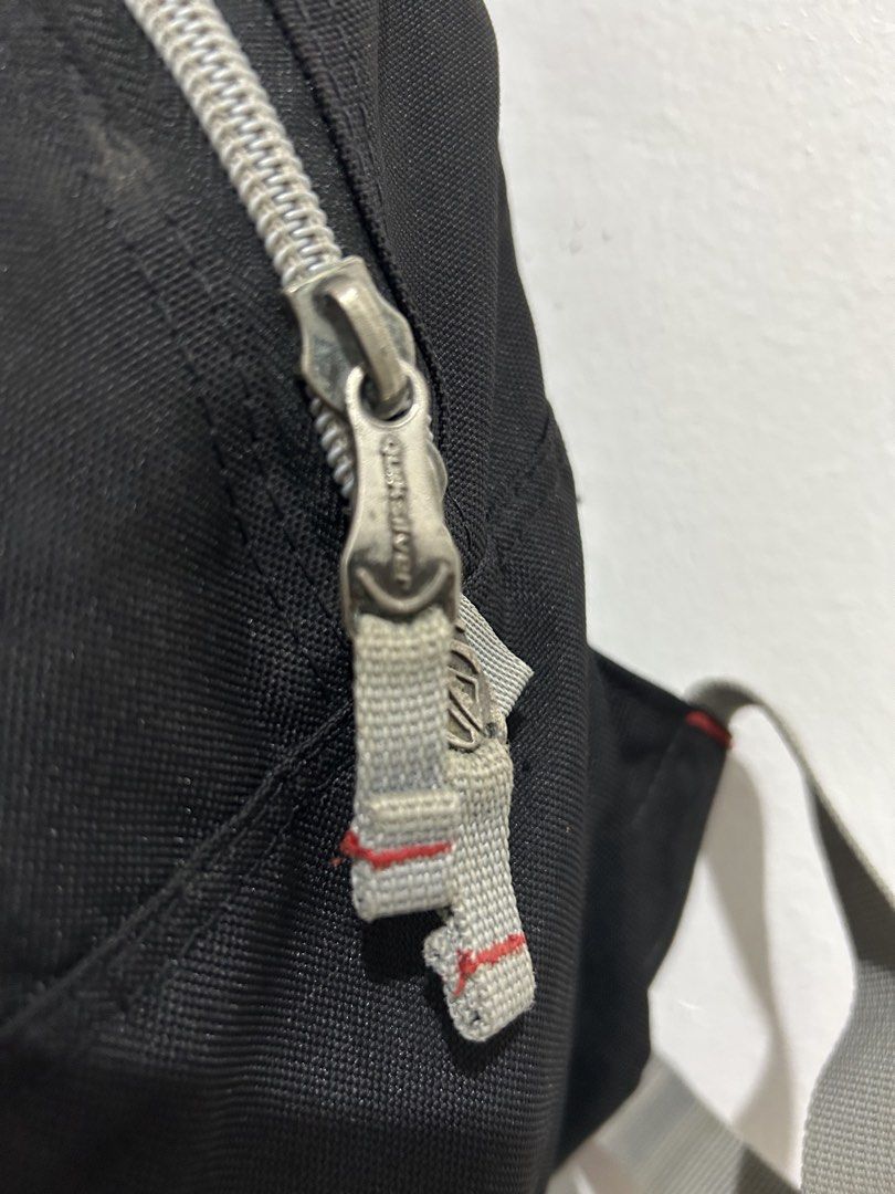 Quiksilver Black Backpack with Grey Straps (Category: Backpacks) located in Angeles City. Submitted by cassey_phoenix (Listing ID 1466882084, Image 3). Description: - Brand: Quiksilver - Color: Black with grey straps and zipper details - Logo: Embroidered front logo and red side tag - Compartments: Main compartment and front zippered pocket - Features: Adjustable shoulder straps and top hanging loop - Material: Durable fabric construction - Condi