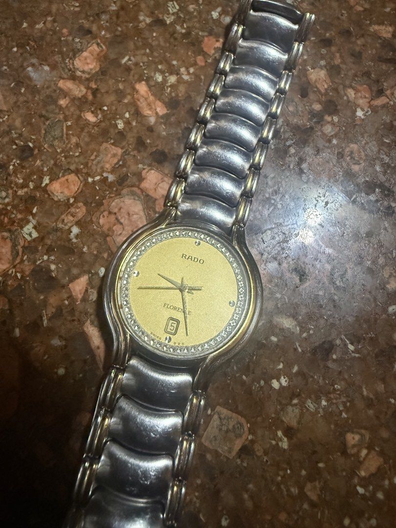 Rado Florence Watch Gold Dial Diamond Bezel (Category: Women's Watches) located in Quezon City. Submitted by kdcarts (Listing ID 1466839718, Image 1). Description: PRICE CAN NEGOTIATE - Brand: Rado Florence - Dial: Luxurious gold dial with date window at 6 o'clock - Bezel: Elegant diamond bezel - Bracelet: Two-tone metal bracelet with comfortable curved links - Movement: Swiss movement - Condition: Minor surface wear from regular use, well-mainta