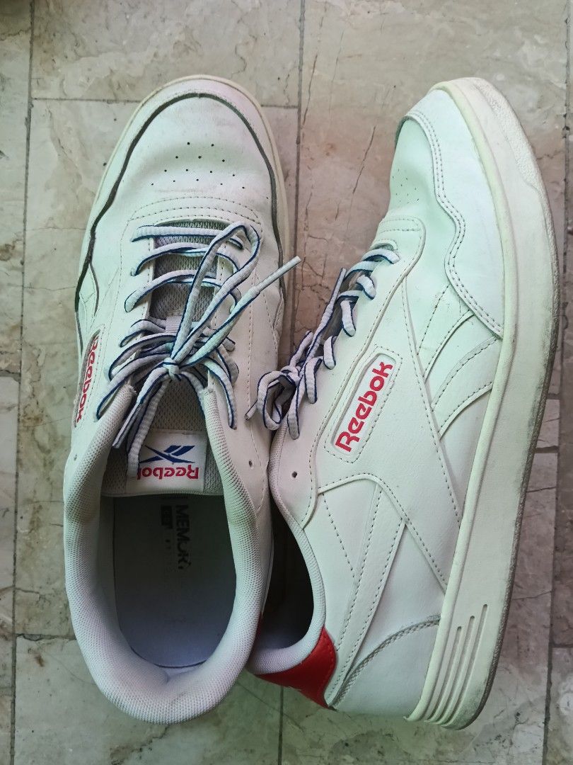 Reebok White Sneakers (Category: Sneakers) located in Quezon City. Submitted by spicyphoenix (Listing ID 1466936333, Image 1). Description: White Reebok sneakers with red accents and blue patterned laces. Leather upper with ventilation holes on the toe box. Memory tech insoles inside for extra cushioning. Some yellowing on the midsoles and light creasing from wear..