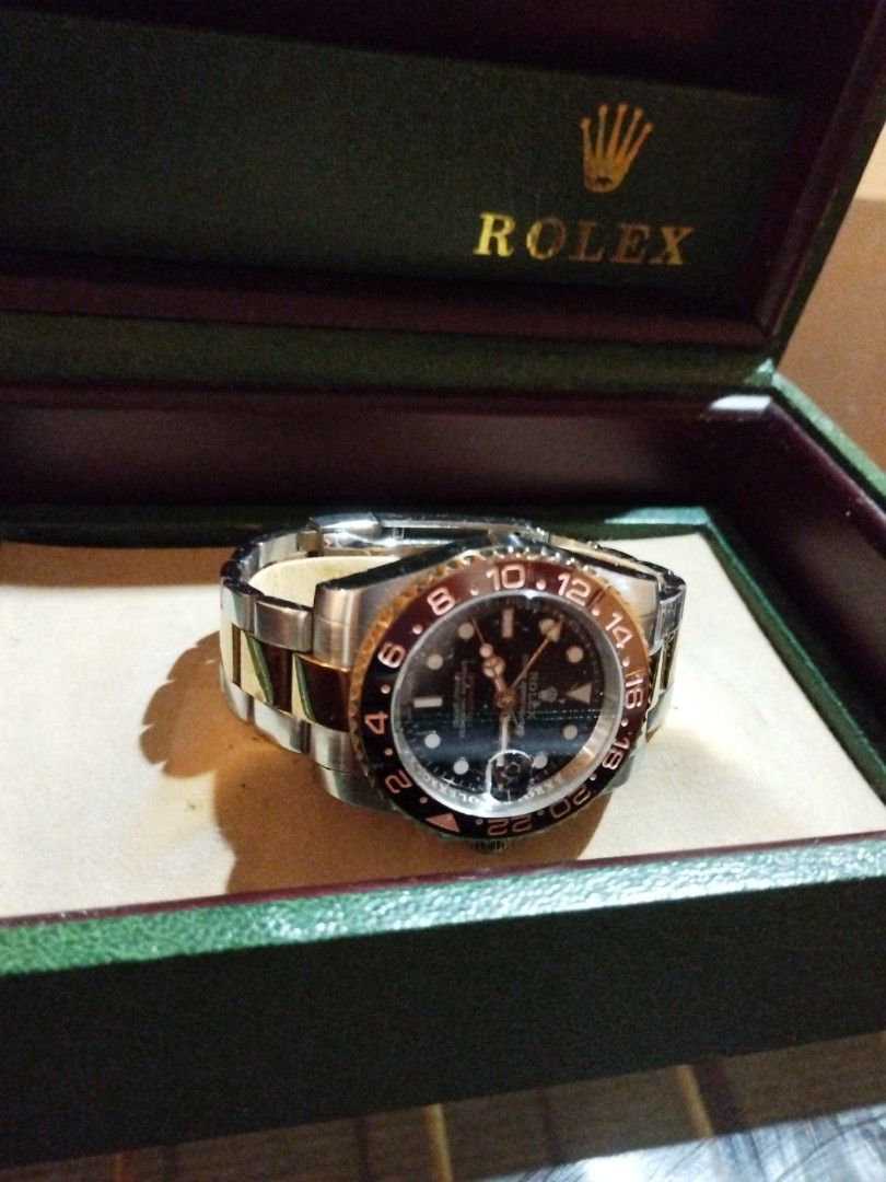 Rolex GMT-Master II Root Beer Watch with Box (Category: Luxury Watches) located in Quezon City. Submitted by coy_888 (Listing ID 1466925833, Image 3). Description: - Authentic Rolex GMT-Master II in two-tone steel and yellow gold - Working condition - Striking black dial with luminous gold hour markers and hands - Iconic brown and black Cerachrom bezel insert - Comfortable Oyster bracelet with polished center links - Includes green Rolex presenta