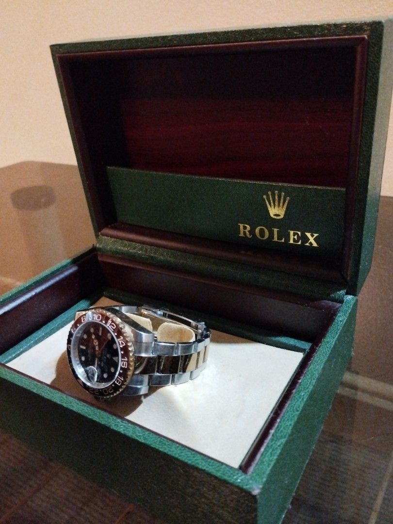 Rolex GMT-Master II Root Beer Watch with Box (Category: Luxury Watches) located in Quezon City. Submitted by coy_888 (Listing ID 1466925833, Image 2). Description: - Authentic Rolex GMT-Master II in two-tone steel and yellow gold - Working condition - Striking black dial with luminous gold hour markers and hands - Iconic brown and black Cerachrom bezel insert - Comfortable Oyster bracelet with polished center links - Includes green Rolex presenta