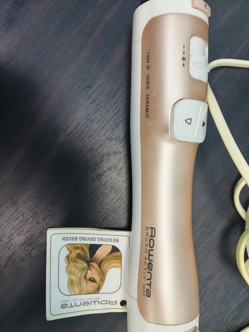 Rowenta Brush Activ 1000 Rotating Drying Brush (Category: Hair) located in Manila. Submitted by artsylove24 (Listing ID 1466787128, Image 2). Description: - Brand: Rowenta Brush Activ 1000 - Color: Chic Rose Gold and White - Power: 1000W with ionic and ceramic technology for frizz-free shine - Features: Automatic rotation with easy directional buttons - Attachments: Includes two interchangeable brush heads for drying and styling simultaneously - 