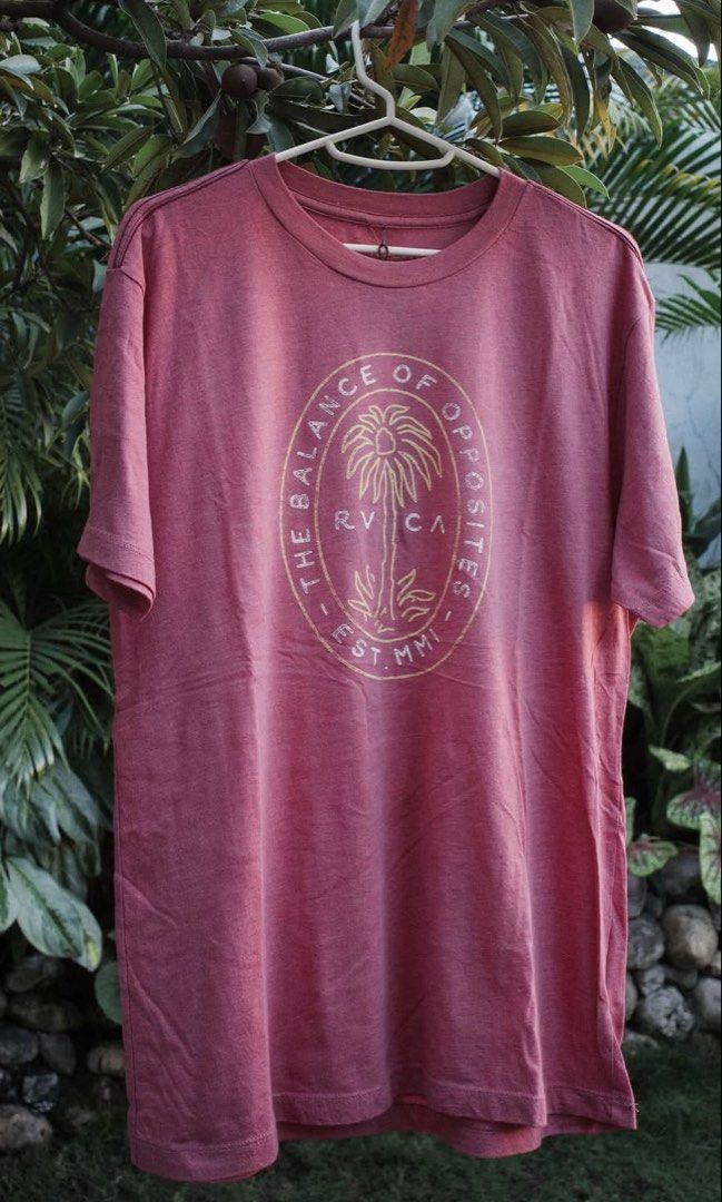 RVCA Vintage Dye Red Medium T-Shirt (Category: Tshirts & Polo Shirts ) located in Cebu City. Submitted by declutterbarbie_ (Listing ID 1466833241, Image 1). Description: - Brand: RVCA - Color: Vintage dye red - Size: Medium - Design: Palm tree circular chest graphic with "The Balance of Opposites Est. MMV" text - Fit: Regular short sleeve crewneck - Condition: Soft washed fabric look, great for casual wear or skating.