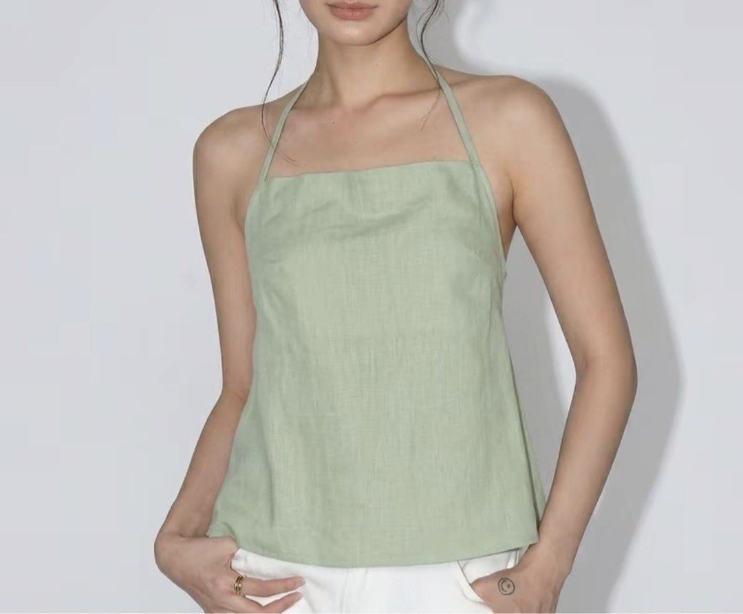 Sage Green Halter Neck Backless Peplum Top (Category: Sleeveless) located in Quezon City. Submitted by m3gan8 (Listing ID 1466786849, Image 3). Description: - Color: Sage green - Style: Halter top with square neckline and flowy peplum hem - Back Details: Open back with double straps and adjustable sliders - Fabric: Lightweight, ideal for warm weather - Condition: Worn a couple of times, still in solid shape.