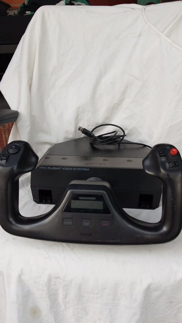 Saitek Pro Flight Yoke System (Category: Controllers) located in Quezon City. Submitted by jpnvintageonline (Listing ID 1466895984, Image 2). Description: - Saitek Pro Flight Yoke System for flight simulators - Fully tested and 100% working condition - Built-in chronometer and integrated USB cable - Features multiple buttons, switches, and a distinct red fire button - Plug-and-play setup for PC, Microsoft Flight Simulator, and X-Plane - Normal co