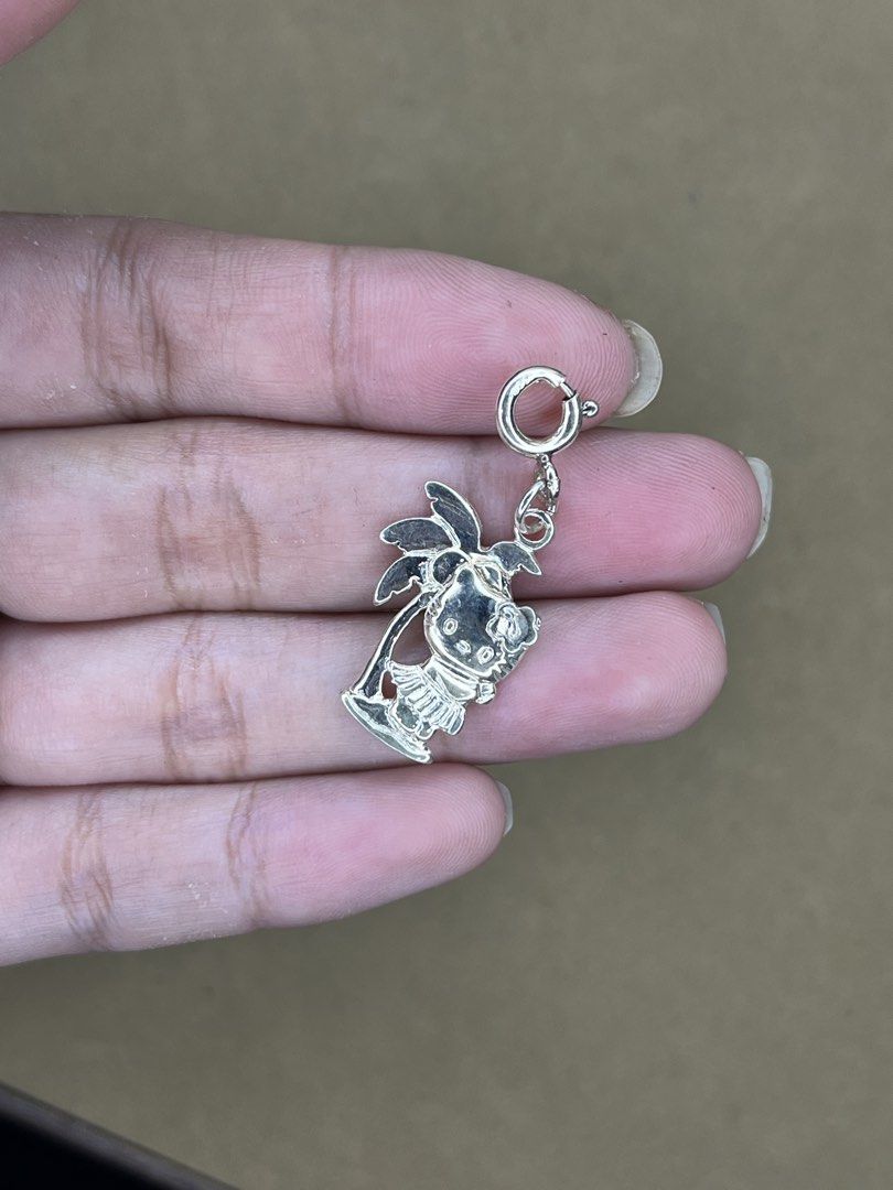 Sanrio Hello Kitty 2006 Hula Palm Tree 925 Silver Charm (Category: Charms) located in Bulacan. Submitted by vintagetreasureby.mivida (Listing ID 1466957908, Image 2). Description: - Authentic 2006 Sanrio Kitty hula charm - Crafted from solid sterling silver (stamped 925) - Features a cute tropical design with Kitty and a palm tree - Official Sanrio copyright text on the back - Equipped with a spring ring clasp for easy clipping onto bracelets or 