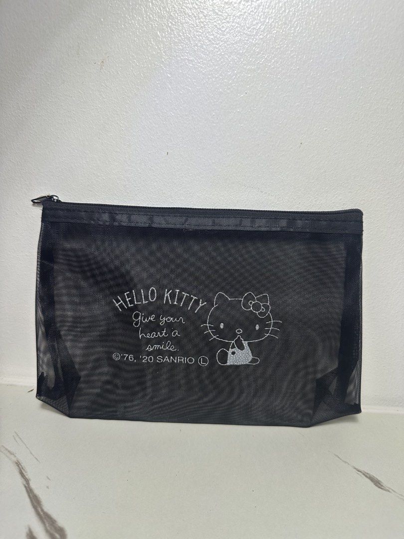 Sanrio Hello Kitty Black Mesh Zipper Pouch (Category: Purses & Pouches) located in Quezon City. Submitted by swift.thriftz (Listing ID 1466901413, Image 1). Description: - Authentic Sanrio Kitty merchandise with 1976/2020 copyright - Features ' KITTY Give your heart a smile' graphic print - Durable and lightweight black mesh material - Secure top zipper closure - Ideal for organizing stationery, makeup, or small daily essentials.