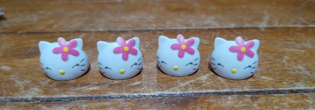 Sanrio Hello Kitty Flower Ring Set of 4 (Category: Rings) located in Manila. Submitted by janetecson05 (Listing ID 1466876021, Image 1). Description: - Set of 4 adorable Kitty rings - Features white plastic bands with molded faces and pink flower accessories - Adjustable open-back design to fit most sizes - Authentic Sanrio items stamped with © '76 SANRIO and model code HC4011 - Great gift for Sanrio collectors and fans.