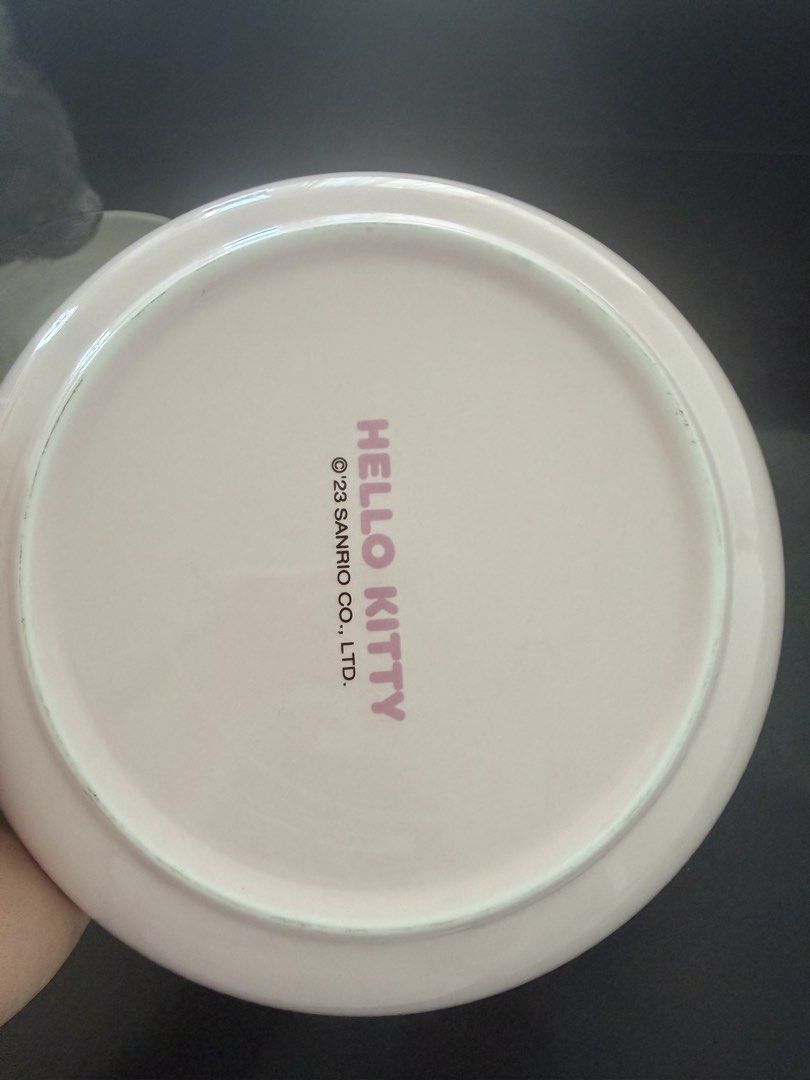 Sanrio Hello Kitty Pink Ceramic Dinner Plate 2023 (Category: Dinnerware & Cutlery) located in Taguig. Submitted by mengxir20193848 (Listing ID 1466813413, Image 2). Description: - Official 2023 Sanrio merchandise (stamp on bottom) - Color: Light pink with a white rim - Design: Cute waving Kitty graphic - Material: Durable, easy-to-wash ceramic - Versatile size great for meals, snacks, or desserts - Perfect addition for any Sanrio collector.