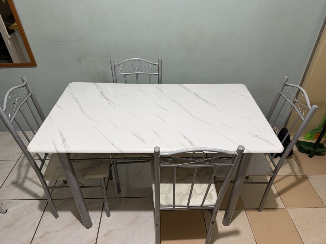 San-Yang Dining Set 4-seater (Used) (Category: Tables & Sets) located in Quezon City. Submitted by siricaaron (Listing ID 1466809518, Image 3). Description: San-Yang Dining Set 301504 (Used) One Dining Table with Four Dining Chairs Made from White Marble PVC, MDF Size: Table – 120 x 67 x 75 cm (LWH) Chair – 37 x 40 x 90 Color: Marble pattern and Gray Weight: 41kg Easy to Clean Stylish and Multifunctional Very accessible price Pickup via Lalamove 