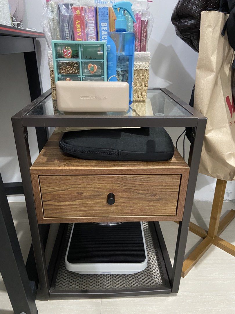 Sanyang Side Table Good As New No Issues (Category: Tables & Sets) located in Quezon City. Submitted by seandimes (Listing ID 1466909003, Image 1). Description: Sanyang Side Table Good As New No Issues - Metal frame nightstand with glass top shelf - Features a convenient wooden pull-out drawer - Mesh lower shelf for extra storage - Compact size ideal for bedrooms or small study areas - Stable structure with clean lines and neutral colors - Good f
