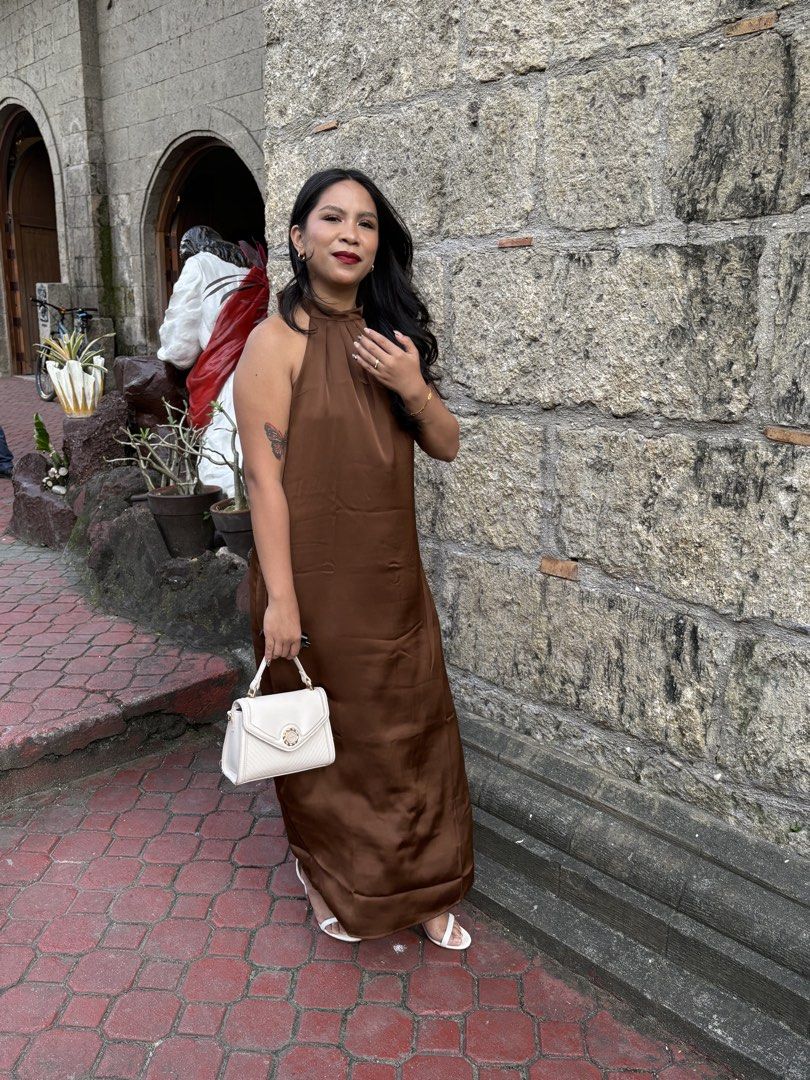 Satin Brown Halter Neck Maxi Dress (Category: Dresses) located in Quezon City. Submitted by danayuhhh_ (Listing ID 1466781127, Image 3). Description: - Color: Rich chocolate brown - Style: Halter neckline, open back with tie closure, floor-length - Material: Smooth satin with a subtle sheen - Condition: Excellent, worn once for a wedding - Occasion: Ideal for evening parties and formal events - Mode of Payment: bank transfer preferred - Shipping:
