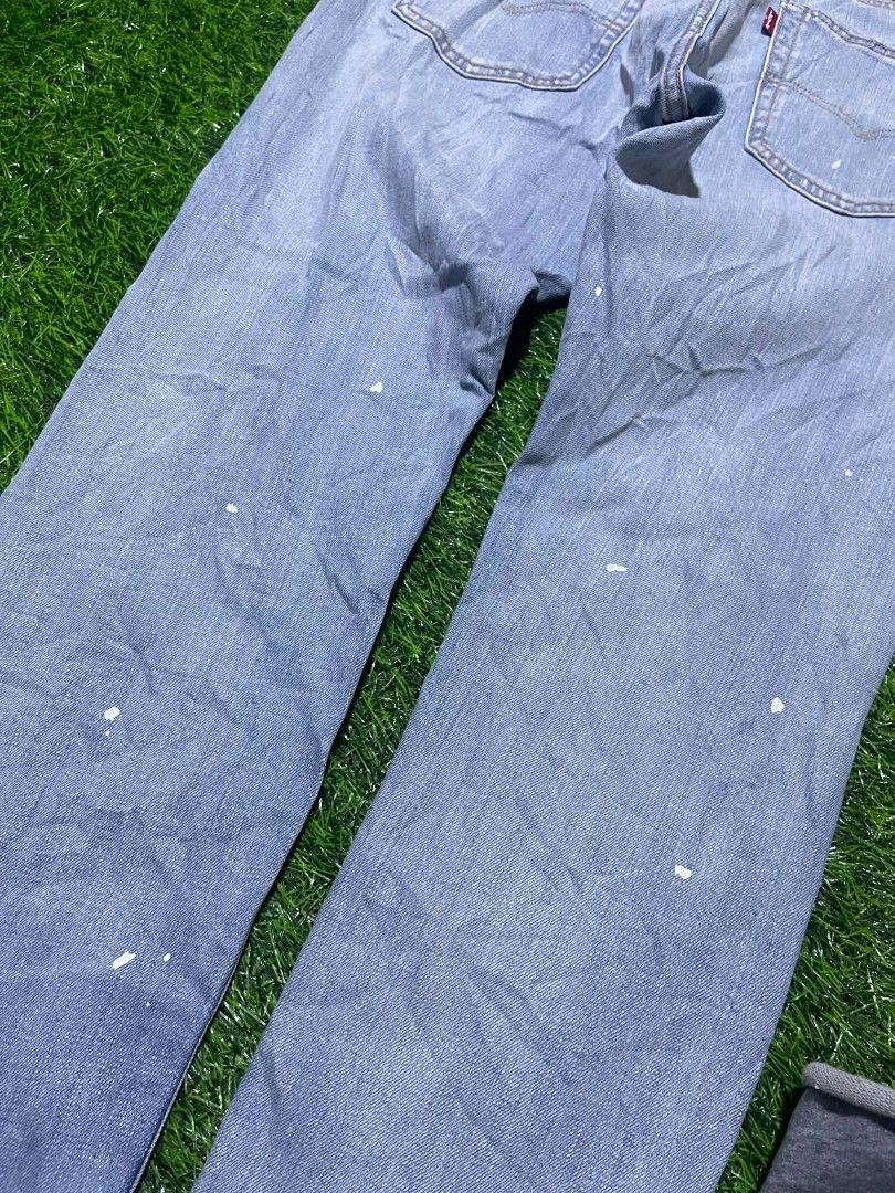 Selvedge Levi's 512 Light Wash (Category: Jeans) located in Pangantucan. Submitted by calmwhale_cb83a8 (Listing ID 1466795051, Image 2). Description: - Brand: Levi's - Size: W32 L32 - Wash: Light wash denim with trendy paint splatters - Details: Classic button fly, leather back patch, and iconic red tab - Hem: Cuffed with blue contrast lining - Condition: Durable fabric with stylish pre-existing distress - Style: Casual everyday look.