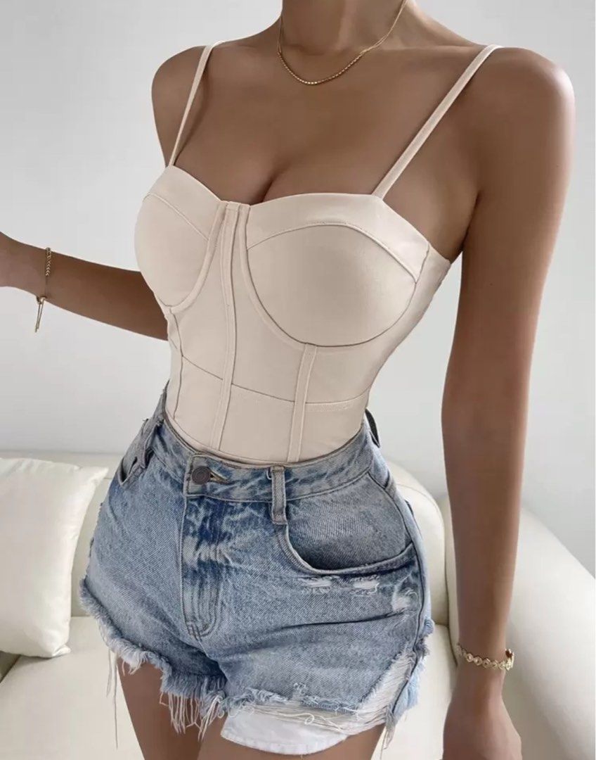 Shein Beige Corset Bodysuit (Category: Sleeveless) located in Manila. Submitted by goddesssy (Listing ID 1466909680, Image 1). Description: Beige corset bodysuit with structured cups and underwire detailing. Adjustable thin spaghetti straps. Seamed bodice design contours the waist. Thong-style bottom with snap closure. Soft stretch fabric hugs the body closely. Pairs great with denim shorts or high-waisted jeans..