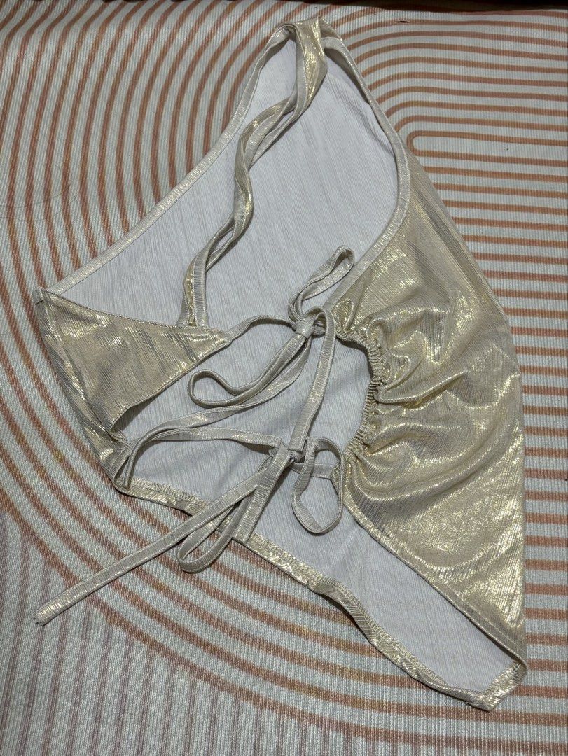 Shein Gold Metallic Tie-Back One-Sided Top (Category: Sleeveless) located in Quezon City. Submitted by eybiiii (Listing ID 1466919005, Image 2). Description: - Brand: Shein - Color: Gold metallic with shimmer finish - Size: L on tag but can fit S-M - Design: one-sided top, open back, adjustable tie-back straps - Condition: Worn once for a quick photo shoot, basically untouched/like new - Perfect for: Night outs, parties, and content creation.