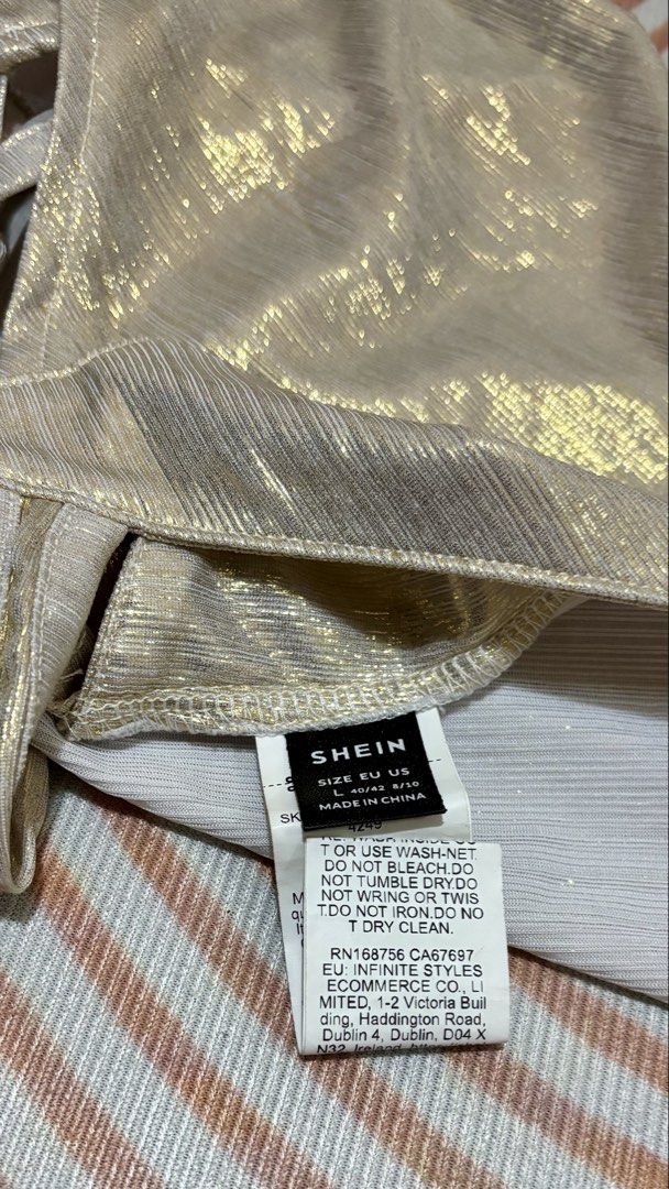 Shein Gold Metallic Tie-Back One-Sided Top (Category: Sleeveless) located in Quezon City. Submitted by eybiiii (Listing ID 1466919005, Image 3). Description: - Brand: Shein - Color: Gold metallic with shimmer finish - Size: L on tag but can fit S-M - Design: one-sided top, open back, adjustable tie-back straps - Condition: Worn once for a quick photo shoot, basically untouched/like new - Perfect for: Night outs, parties, and content creation.