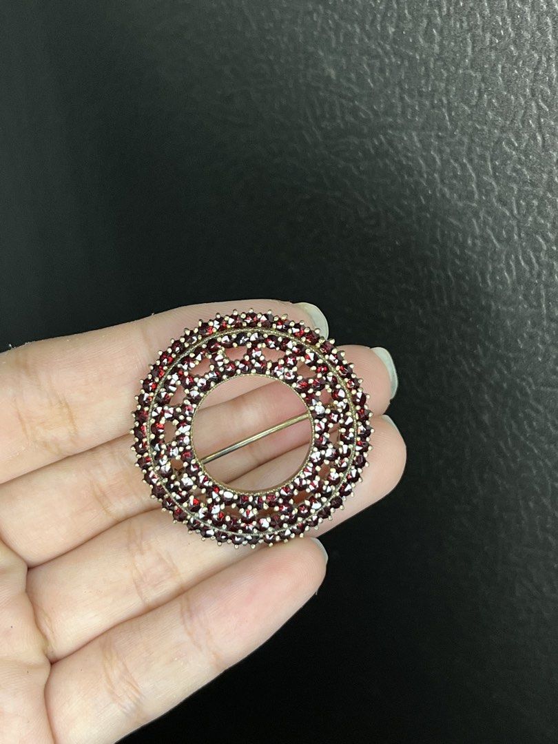 Silver Vintage Garnet Circular Cluster Brooch Pin (Category: Brooches) located in Bulacan. Submitted by vintagetreasureby.mivida (Listing ID 1466957643, Image 2). Description: Round openwork brooch covered entirely in deep red garnet gemstones. Secure pin clasp on the reverse side with pierced metal backing to let the light through the stones. Measures a handy size for jackets, scarves, or lapels. Classic heirloom look, heavy clustering of tiny c