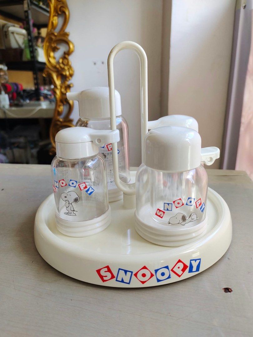 Snoopy Condiment Dispenser Set with Rotating Stand (Category: Food Organization & Storage) located in Manila. Submitted by janetecson05 (Listing ID 1466863209, Image 2). Description: - Authentic Snoopy condiment dispenser set - Includes 4 glass bottles with easy-to-use white pump lids - Comes with a convenient rotating stand - Features classic Snoopy graphics and retro red-and-blue lettering - Original box included, great for gifting or collector