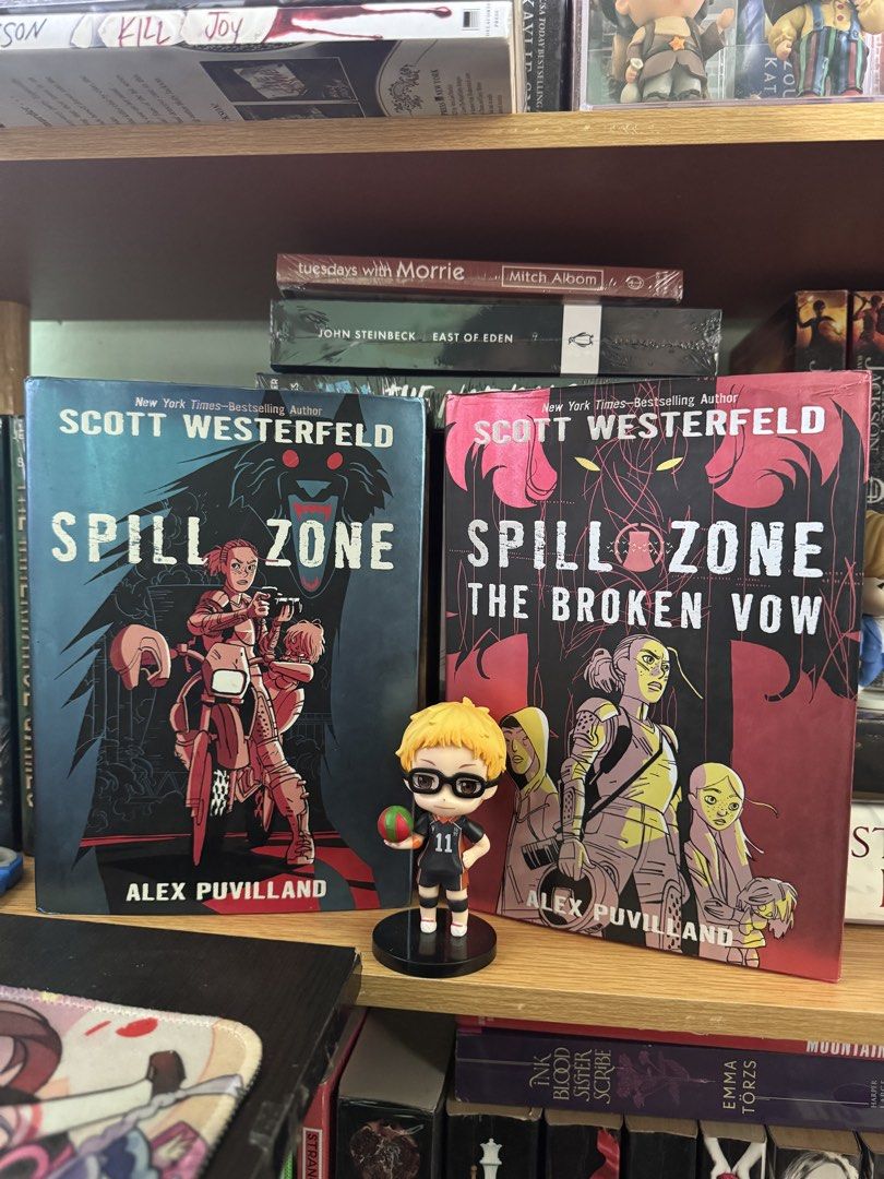 Spill Zone Book Set by Scott Westerfeld (Category: Storybooks) located in Glan. Submitted by jvalerie (Listing ID 1466778140, Image 1). Description: - Titles included: Spill Zone and Spill Zone The Broken Vow - Author/Artist: Written by Scott Westerfeld, illustrated by Alex Puvilland - Format: Hardcover editions with colorful cover art - Condition: Excellent, neatly stored on a shelf - Perfect for graphic novel fans and collectors.