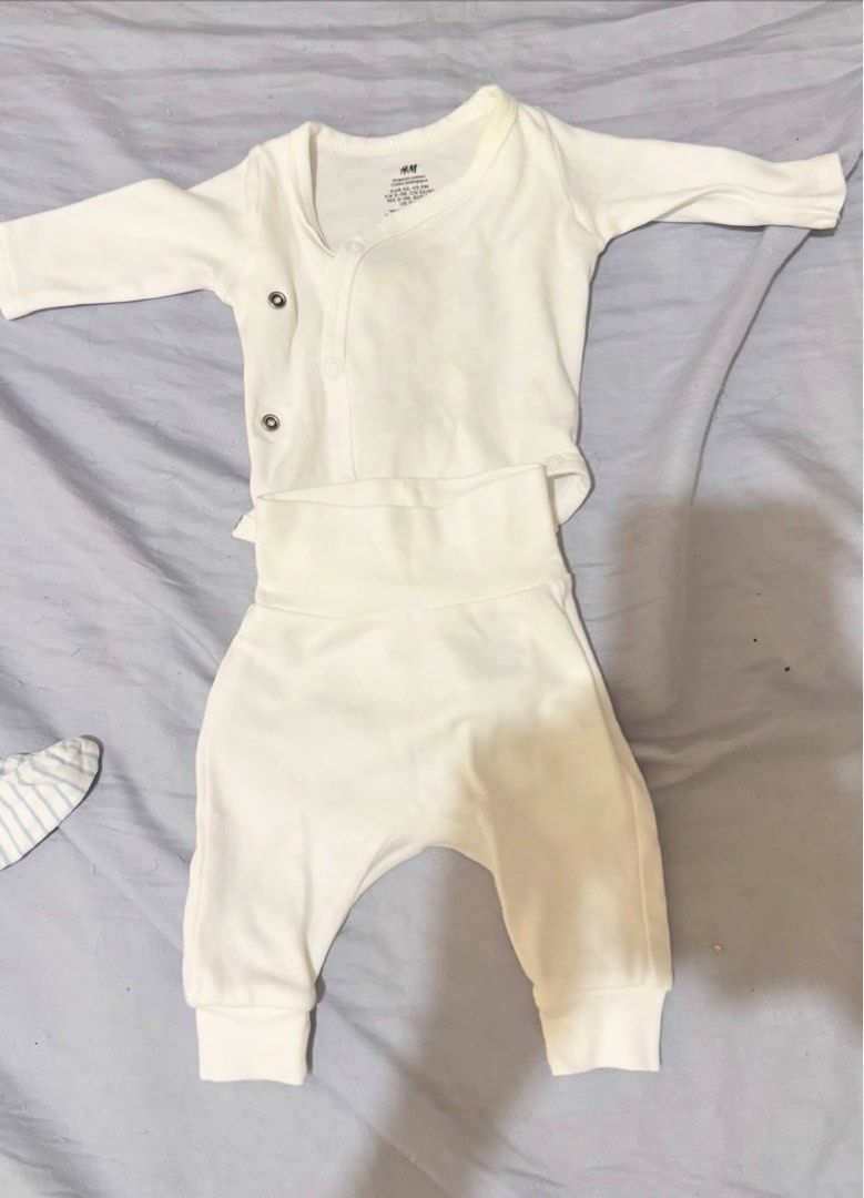 St. Patrick & H&M Ternos (Category: Babies & Kids Fashion) located in Makati City. Submitted by akimoie (Listing ID 1466783326, Image 2). Description: - Set of 3 newborn clothing sets (St. Patrick & H&M brands) - Includes blue striped top with footed pants, light blue top with footed pants, and solid white side-snap top with high-waisted pants - Made from ultra-soft cotton, gentle on baby's skin - Unisex bundle, great for newborn boys or girls - 
