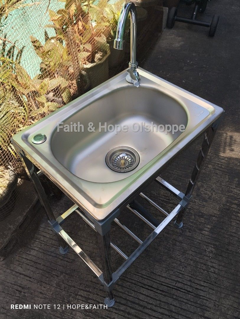 Stainless Steel Kitchen Sink with Stand (Category: Bathroom & Kitchen Fixtures) located in Manila. Submitted by jamfrimzy089458 (Listing ID 1466842875, Image 3). Description: Stainless steel single bowl sink mounted on a sturdy metal frame stand. Includes a tall gooseneck faucet, flexible drainage hose, and a lower storage shelf for kitchen essentials. Easy to assemble, compact setup suitable for indoor or outdoor washing areas. Sturdy legs keep 