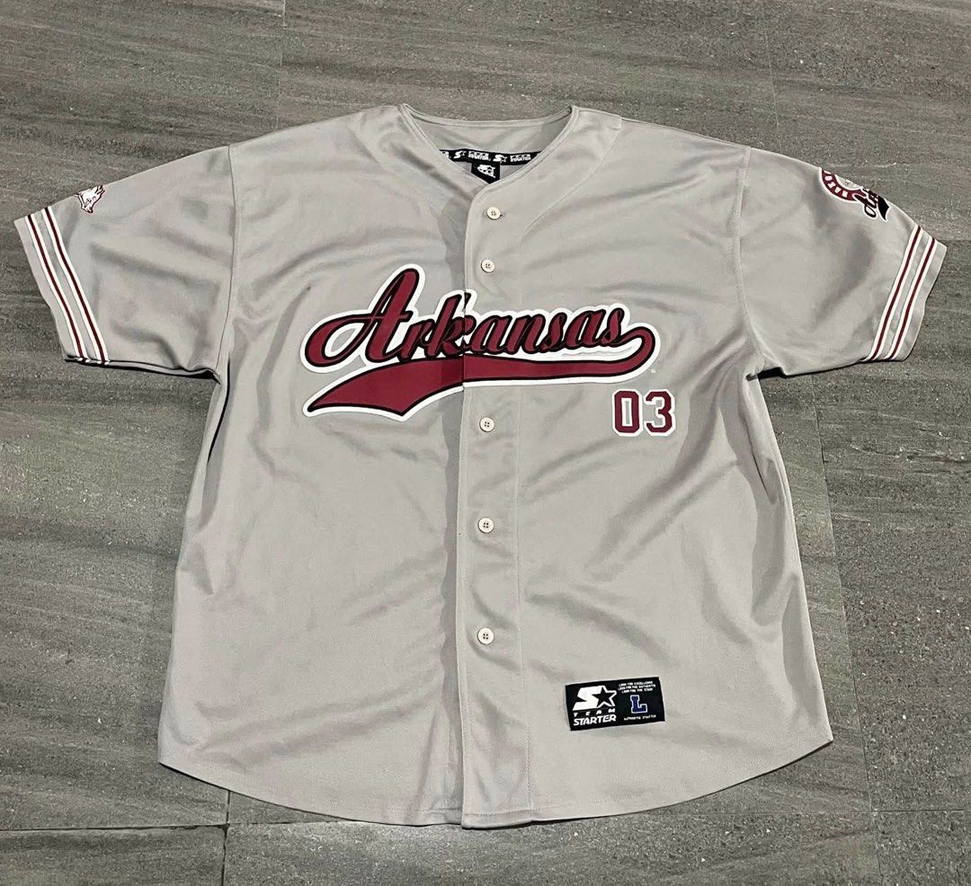 Starter Arkansas Razorbacks Grey Baseball Jersey Size L (Category: Activewear) located in Quezon City. Submitted by lucky_wisefish.2ca7d6 (Listing ID 1466965758, Image 1). Description: - Brand: Starter - Team: Arkansas Razorbacks - Color: Grey with maroon and white accents - Size: Large - Details: Maroon script embroidery with number 03, striped sleeve cuffs, stitched team patch near hem - Closure: Button-front - Condition: Clean, great pre-loved