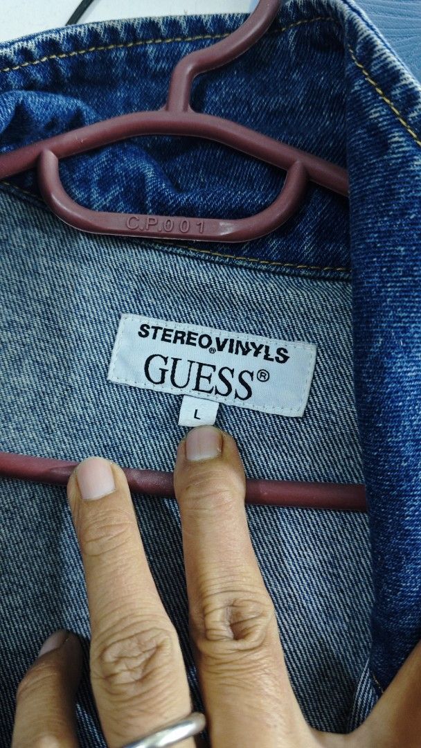 Stereo Vinyls x Guess Denim Jacket Size L (Category: Coats, Jackets and Outerwear) located in Davao. Submitted by jhinkertzp55934 (Listing ID 1466907661, Image 2). Description: - Brand: Stereo Vinyls x Guess - Item: Collaborative Denim Jacket - Color: Blue - Size: L dimes 25x28 - Material: Heavy denim fabric - Details: Graphic print portrait panels on front and placket, classic button-up front, contrast yellow stitching, chest pockets, and signat