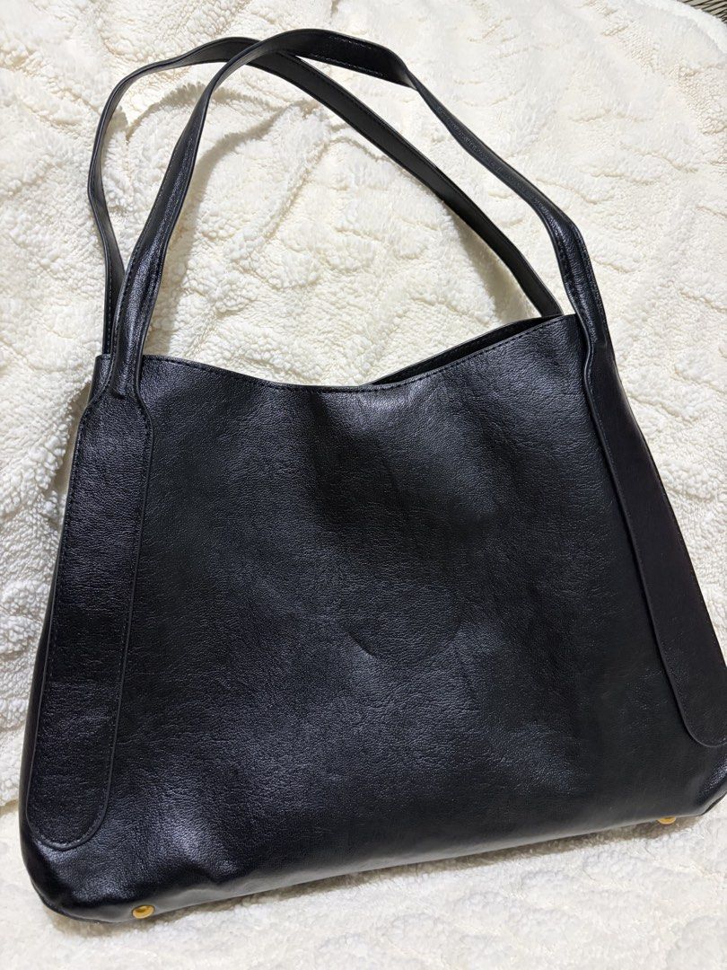 Steve Madden Black Shoulder Bag with Tassels (Category: Shoulder Bags) located in Paranaque City. Submitted by greatfinds108 (Listing ID 1466832434, Image 2). Description: - Brand: Steve Madden - Color: Black with luxury gold-tone hardware - Material: Durable faux leather - Design: Structured base with protective metal feet - Straps: Convenient double shoulder straps - Compartments: 2 side zipper pockets design with stylish tassel pulls, plus a m