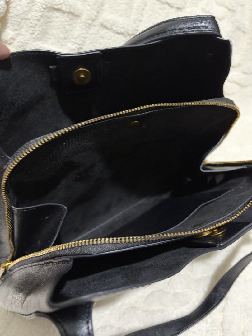 Steve Madden Black Shoulder Bag with Tassels (Category: Shoulder Bags) located in Paranaque City. Submitted by greatfinds108 (Listing ID 1466832434, Image 3). Description: - Brand: Steve Madden - Color: Black with luxury gold-tone hardware - Material: Durable faux leather - Design: Structured base with protective metal feet - Straps: Convenient double shoulder straps - Compartments: 2 side zipper pockets design with stylish tassel pulls, plus a m