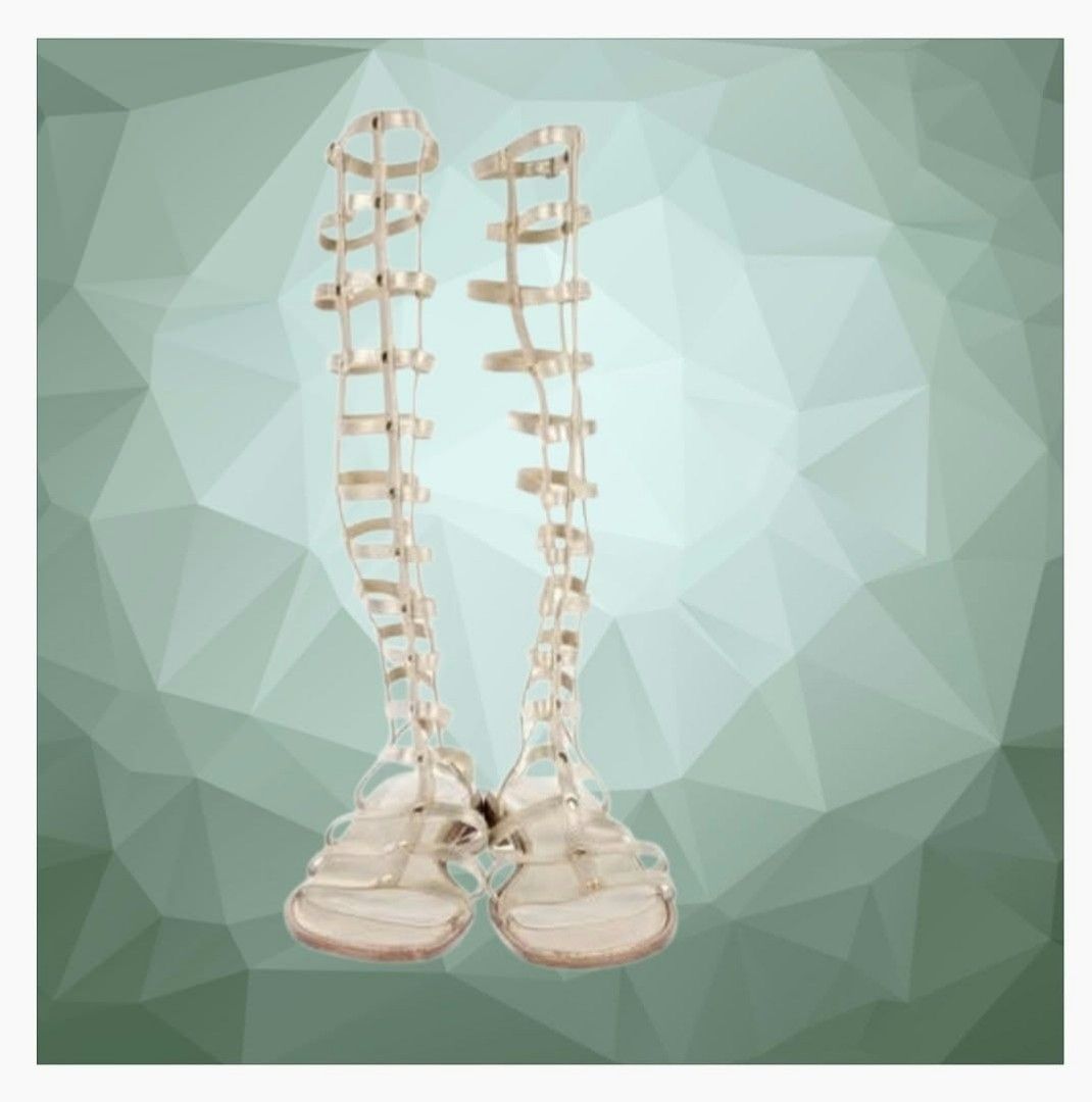 Stuart Weitzman Gold Knee-High Gladiator Sandals (Category: Sneakers & Footwear) located in Paranaque City. Submitted by calm_youngstore7 (Listing ID 1466946034, Image 3). Description: Stuart Weitzman Metallic Leather Gladiator Flat Sandals in gold. This eye-catching design features a towering, knee-high caged silhouette constructed with structural metallic gold leather vertical bars and flexible horizontal straps that comfortably conform to the 