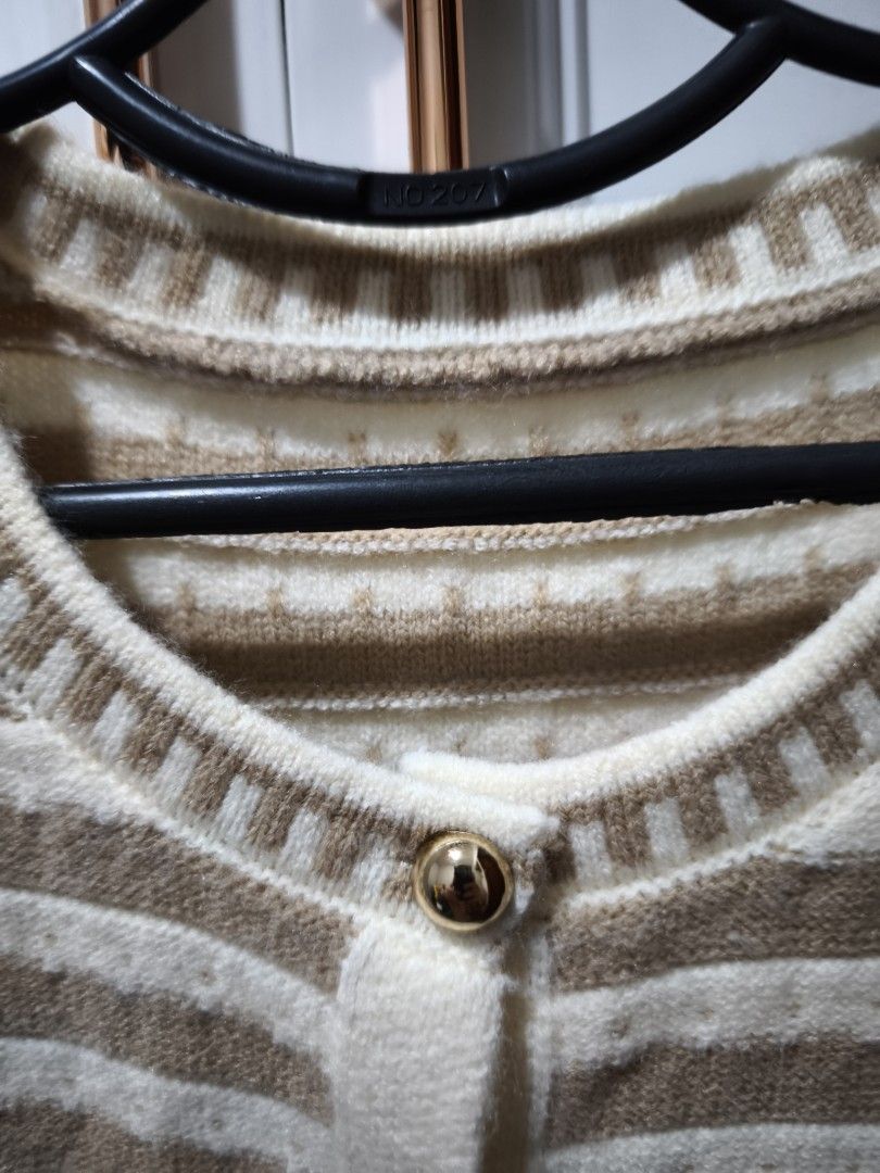 Striped Knit Button-Up Sweater Vest (Category: Sleeveless) located in Manila. Submitted by glendamae16 (Listing ID 1466890667, Image 3). Description: - Brown and white striped knit vest - Features a round neckline with decorative trim and shiny gold-tone front buttons - Sleeveless design, perfect for layering over shirts - Ribbed hem and arm openings with a soft, textured fabric - Good overall condition, ready to wear.