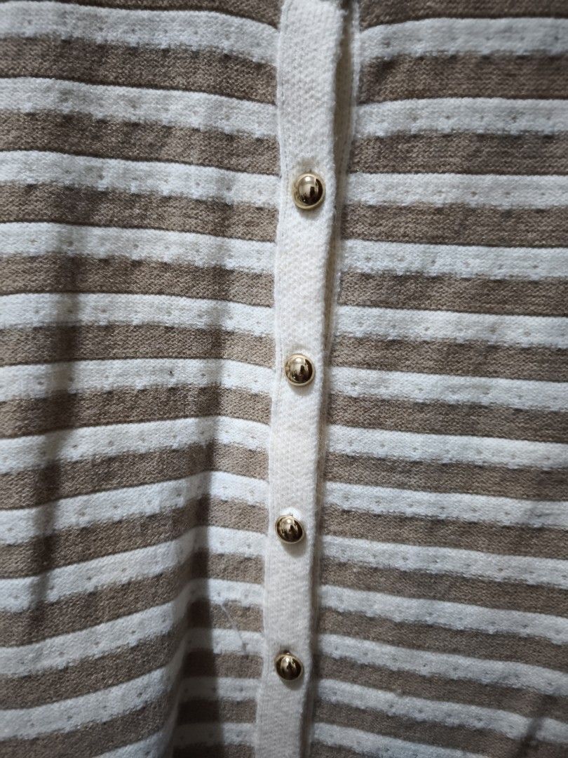 Striped Knit Button-Up Sweater Vest (Category: Sleeveless) located in Manila. Submitted by glendamae16 (Listing ID 1466890667, Image 2). Description: - Brown and white striped knit vest - Features a round neckline with decorative trim and shiny gold-tone front buttons - Sleeveless design, perfect for layering over shirts - Ribbed hem and arm openings with a soft, textured fabric - Good overall condition, ready to wear.
