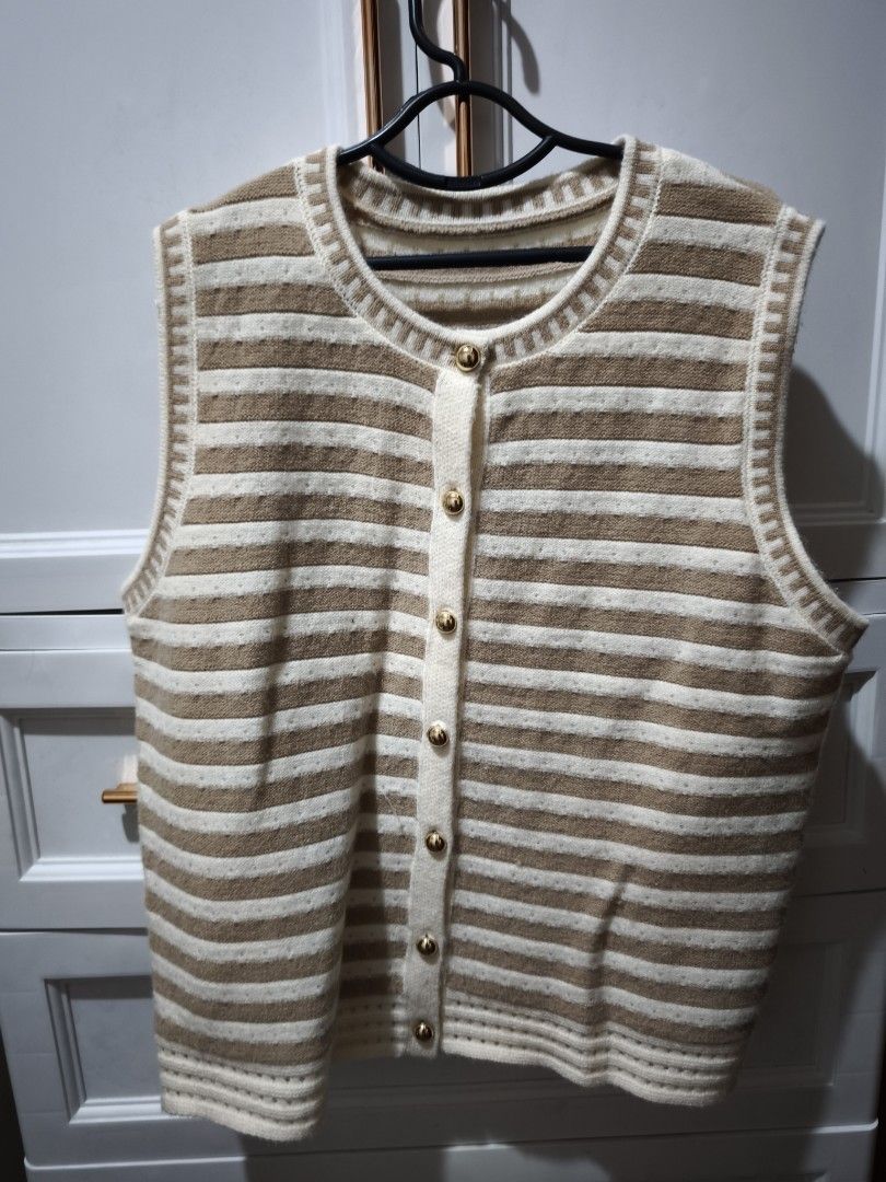 Striped Knit Button-Up Sweater Vest (Category: Sleeveless) located in Manila. Submitted by glendamae16 (Listing ID 1466890667, Image 1). Description: - Brown and white striped knit vest - Features a round neckline with decorative trim and shiny gold-tone front buttons - Sleeveless design, perfect for layering over shirts - Ribbed hem and arm openings with a soft, textured fabric - Good overall condition, ready to wear.