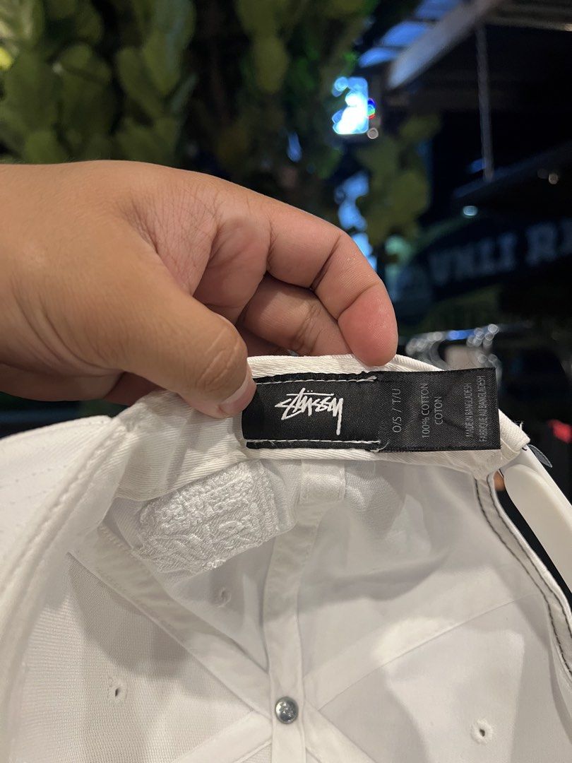 Stüssy White Snapback Hat Cap (Category: Caps & Hats) located in Manila. Submitted by wearurlux_wul (Listing ID 1466808267, Image 3). Description: - Brand: Stüssy - Color: White - Style: Snapback hat / Cap - Fit: Standard OS (One Size, Adjustable) - Material: 100% Cotton - Design: Stitched round logo on front, embroidered global cities (NYC, LA, Tokyo, London, Paris) on the side - Closure: Adjustable plastic snap with small woven logo tab - Condi