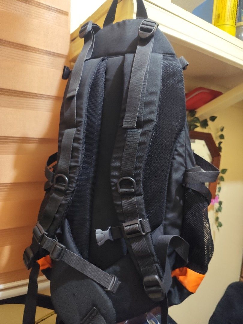 Summit Technical Gear Black and Orange Backpack (Category: Backpacks) located in Naga. Submitted by semflewer (Listing ID 1466830669, Image 3). Description: Summit Technical Gear outdoor backpack in black and bright orange. Multiple compartments, mesh side pockets, and adjustable straps with chest buckle. Built with reflective strips on the front. One small tear on the orange fabric panel inside near the zipper. Ready for hikes, school, or travel