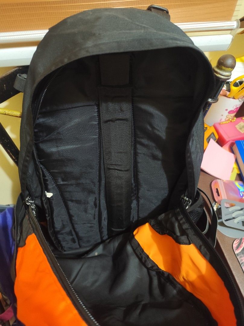 Summit Technical Gear Black and Orange Backpack (Category: Backpacks) located in Naga. Submitted by semflewer (Listing ID 1466830669, Image 2). Description: Summit Technical Gear outdoor backpack in black and bright orange. Multiple compartments, mesh side pockets, and adjustable straps with chest buckle. Built with reflective strips on the front. One small tear on the orange fabric panel inside near the zipper. Ready for hikes, school, or travel