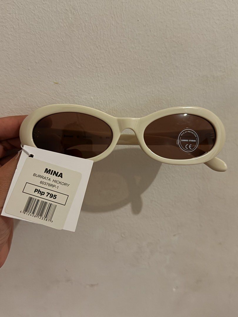 Sunnies Studios Mina Burrata Hickory Sunglasses (Category: Sunglasses & Eyewear) located in Quezon City. Submitted by rds001 (Listing ID 1466803550, Image 1). Description: - Brand: Sunnies Studios - Model: Mina - Colorway: Burrata Hickory - Frame: Cream white, thick oval design - Lenses: Brown tinted with 100% UV protection sticker - Condition: Brand new, never worn, crisp condition - Inclusions: Original store tag with barcode and retail price a
