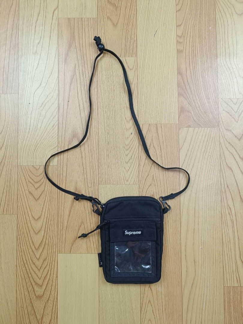 Supreme Black Crossbody Bag (Category: Sling Bags) located in Lapu Lapu. Submitted by margaux099 (Listing ID 1466929416, Image 1). Description: - Color: Black - Style: Crossbody bag with an adjustable strap - Front details: Clear window pouch and small white Supreme box logo label - Interior: White tag printed with Supreme Made in China - Side: Fabric tag attached - Condition: Brand new / Excellent quality - Mode of Payment: GCash, available - Sh