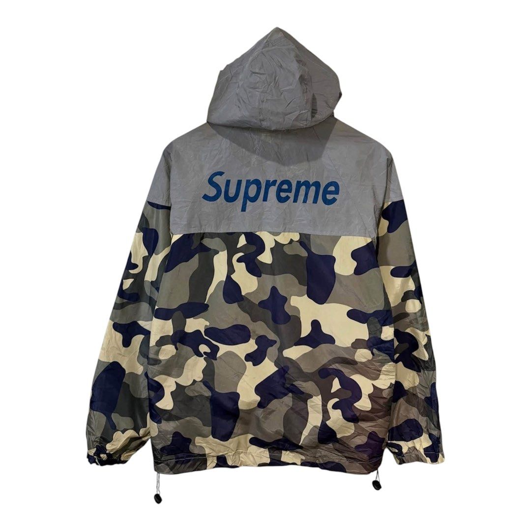 Supreme Camo Windbreaker Jacket Grey Blue Size M (Category: Coats, Jackets and Outerwear) located in Baguio. Submitted by gab_thrift (Listing ID 1466808412, Image 2). Description: - Brand: Supreme - Style: Windbreaker jacket - Colorway: Grey and camo with blue branding - Size: Medium (Made in USA) - Features: Full zip closure, adjustable hood drawstrings, and two zippered hand pockets - Branding: Blue Supreme text printed on the front chest and u