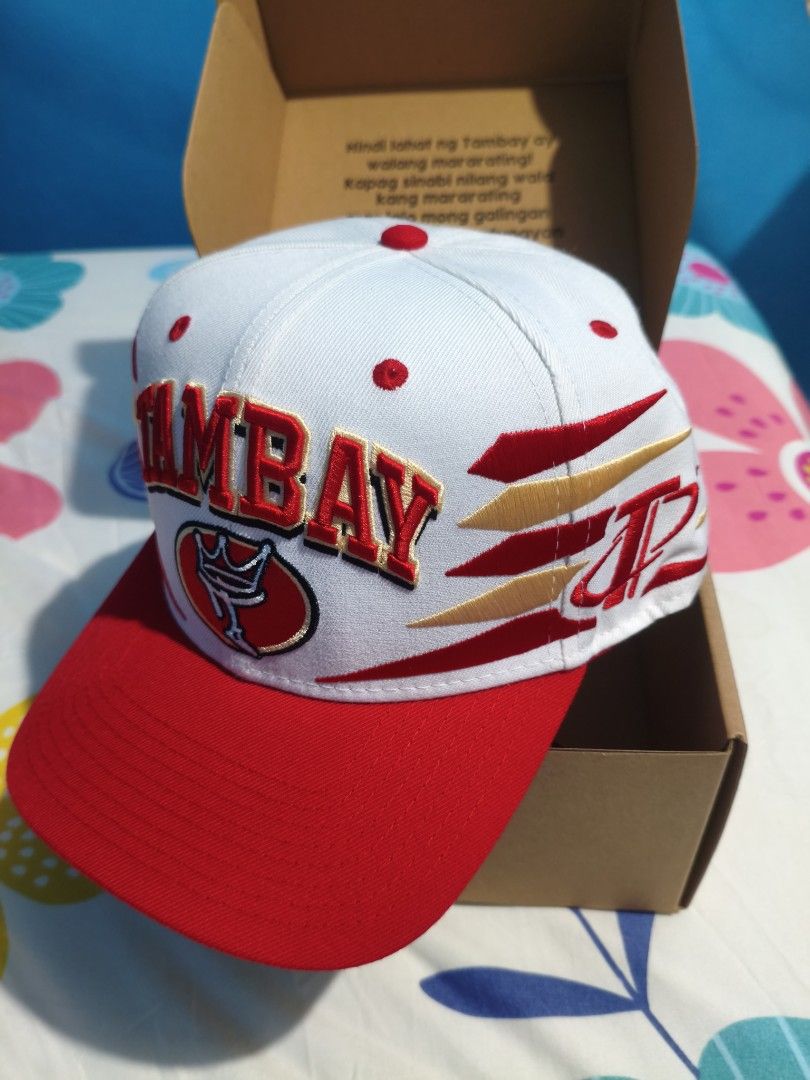 Tambay cap Diamond cut (Category: Caps & Hats) located in Trece Martires City. Submitted by ree617 (Listing ID 1466970882, Image 2). Description: Tambay cap diamond cut w/ signature - Style: Snapback cap in red and white colorway - Design: Bold front embroidery with crown logo and accented side graphics - Details: Classic green underbrim - Condition: Unworn, brand new with tags - Inclusions: Original branded box, sticker pack, and strap accessory
