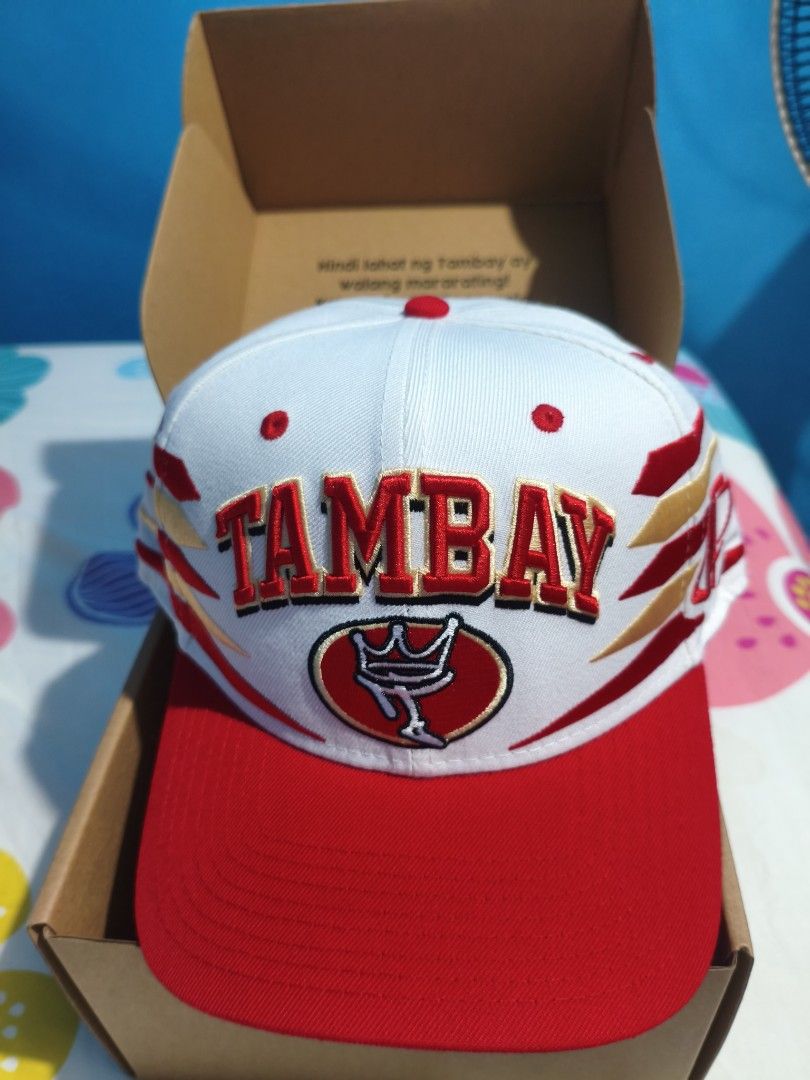 Tambay cap Diamond cut (Category: Caps & Hats) located in Trece Martires City. Submitted by ree617 (Listing ID 1466970882, Image 1). Description: Tambay cap diamond cut w/ signature - Style: Snapback cap in red and white colorway - Design: Bold front embroidery with crown logo and accented side graphics - Details: Classic green underbrim - Condition: Unworn, brand new with tags - Inclusions: Original branded box, sticker pack, and strap accessory