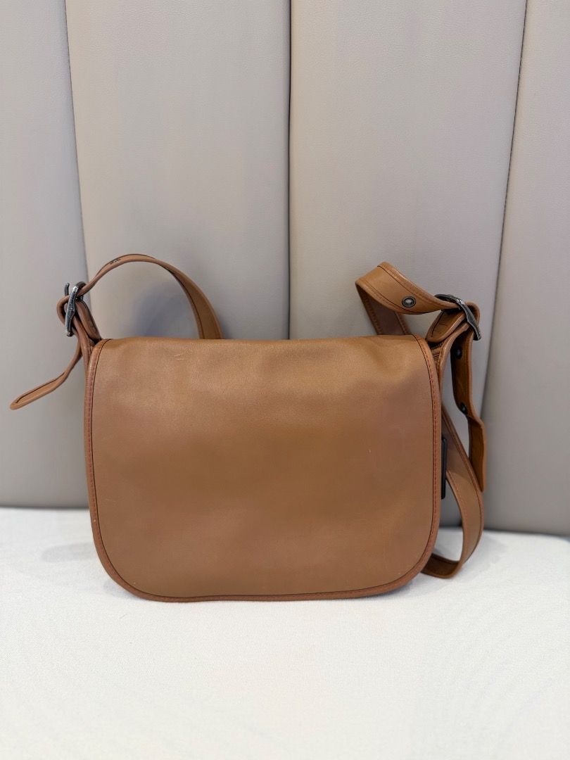 Tan leather shoulder bag with flap closure (Category: Shoulder Bags) located in Rizal. Submitted by je_resada (Listing ID 1466824145, Image 1). Description: - Material: Genuine tan leather with clean edge stitching - Closure: Flap top with a secure zippered main compartment - Interior: Bright orange fabric lining with a handy slip pocket - Exterior: Convenient back slip pocket for easy access - Strap: Adjustable shoulder strap complete with styli