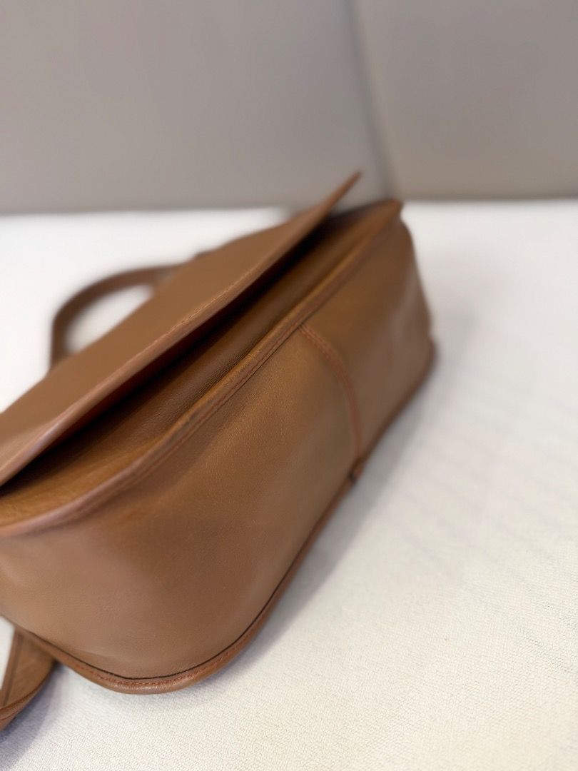 Tan leather shoulder bag with flap closure (Category: Shoulder Bags) located in Rizal. Submitted by je_resada (Listing ID 1466824145, Image 3). Description: - Material: Genuine tan leather with clean edge stitching - Closure: Flap top with a secure zippered main compartment - Interior: Bright orange fabric lining with a handy slip pocket - Exterior: Convenient back slip pocket for easy access - Strap: Adjustable shoulder strap complete with styli