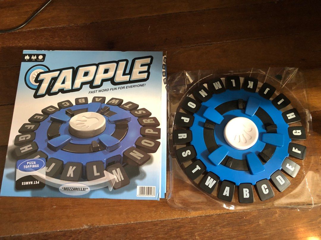 Tapple Fast Word Fun Board Game (Category: Board Games & Puzzles) located in Makati City. Submitted by julieees.closet (Listing ID 1466849575, Image 1). Description: - Game: Tapple by Winning Moves - Condition: Clean, box has minor shelf wear - Inclusions: Blue electronic wheel, complete A-Z letter tabs, category cards, and original box - Features: Fast-paced, easy to learn, perfect party game for family and friends - Note: Free battery inside! -