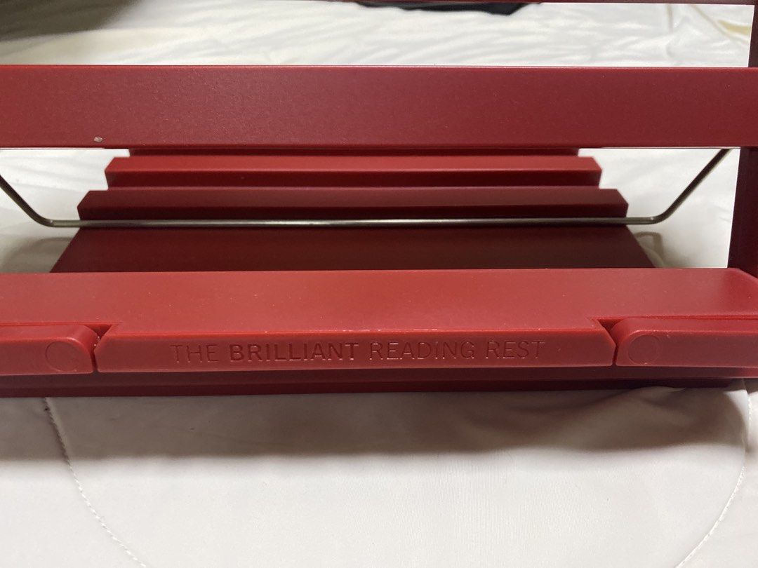 The Brilliant Reading Rest Book Stand (Category: Stationery & School Supplies) located in Pasig City. Submitted by marcspade (Listing ID 1466919379, Image 3). Description: - Color: Chili Red (Fully Booked) - Condition: brand new with tag - Features: Adjustable angles for comfortable reading - Build: Sturdy plastic with a durable metal support arm - Design: Folds completely flat when not in use with branded stamps on front and back - Versatile: Id