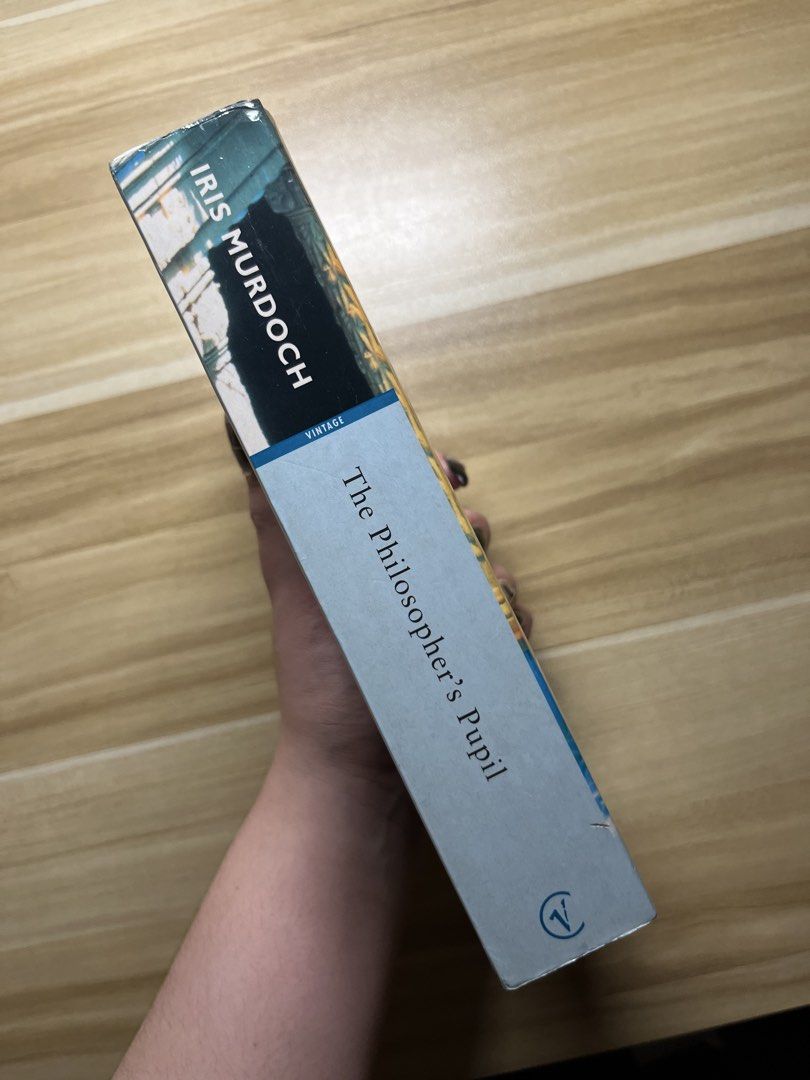 The Philosopher's Pupil by Iris Murdoch (Category: Storybooks) located in Quezon City. Submitted by ekrudieter (Listing ID 1466831156, Image 2). Description: - Title: The Philosopher's Pupil by Iris Murdoch - Edition: Vintage Classics (Includes introduction by Malcolm Bradbury) - Format: Paperback - Condition: Standard reading copy with age spots along the edges, and light shelf wear with minor creases at the spine and corners - Perfect affordabl