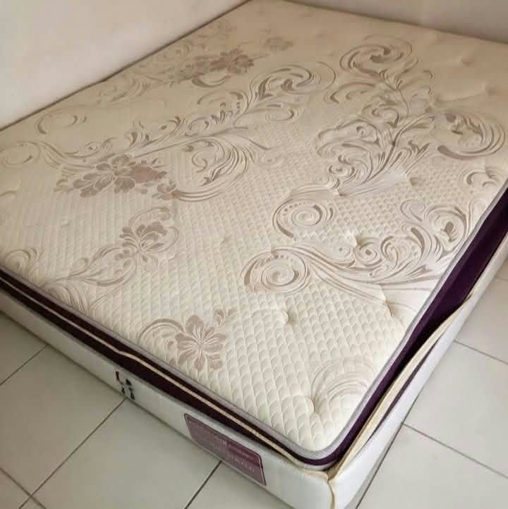 Thick Pillow Top Queen Mattress Floral Pattern (Category: Bed Frames & Mattresses) located in Quezon City. Submitted by mommyof2adorableboys (Listing ID 1466787176, Image 1). Description: - Type: Thick pillow-top mattress - Design: Cream surface with elegant floral swirls and stylish deep purple trim - Features: Quilted texture with tufted buttons for extra comfort - Condition: Clean fabric surface - Details: White sides with brand tags near the 