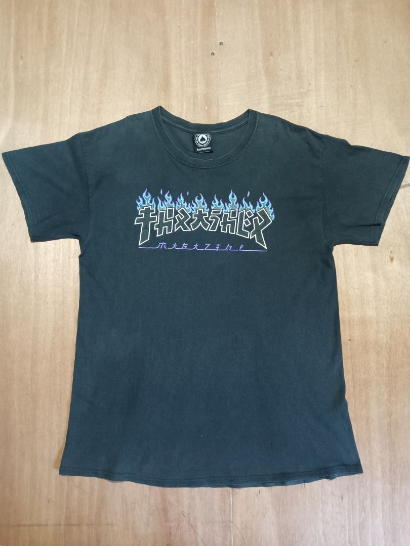 Thrasher Flame Graphic Black T-Shirt (Category: Tshirts & Polo Shirts ) located in Bulacan. Submitted by ken2thrift (Listing ID 1466806108, Image 1). Description: - Color: Black - Design: Blue flame graphic across the chest - Fit: Standard casual fit - Measurements (laid flat): Pit to pit - 20 inches | Length - 29 inches - Condition: Good - Mode of Payment: GCash - Shipping: Via LALAMOVE, J&T or LBC (Buyer shoulders fee).